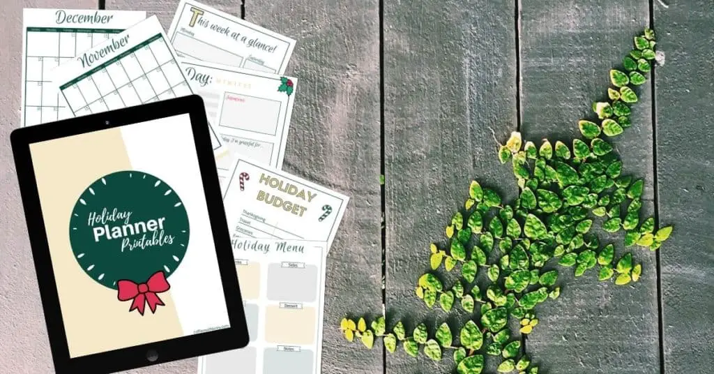 Free Printable Holiday Planner Mockup on Table With Greenery